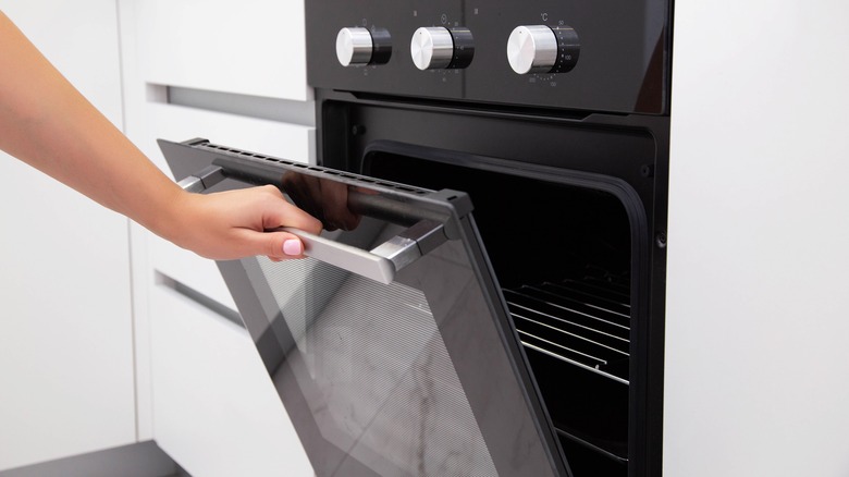 Person opening oven door