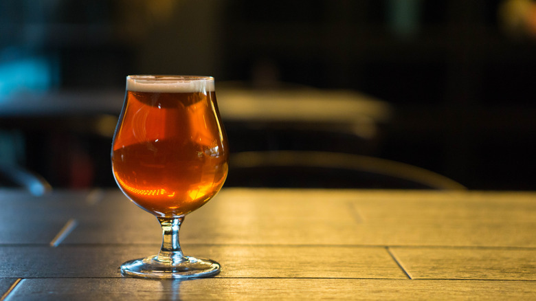 dark ipa sits on table