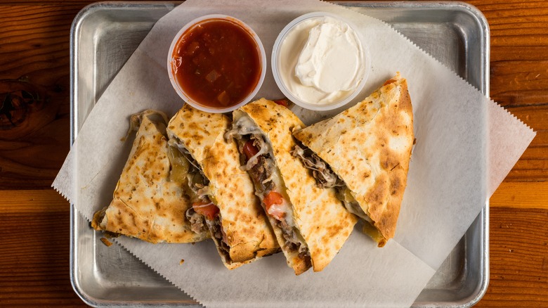 steak quesadilla with salsa and sour cream