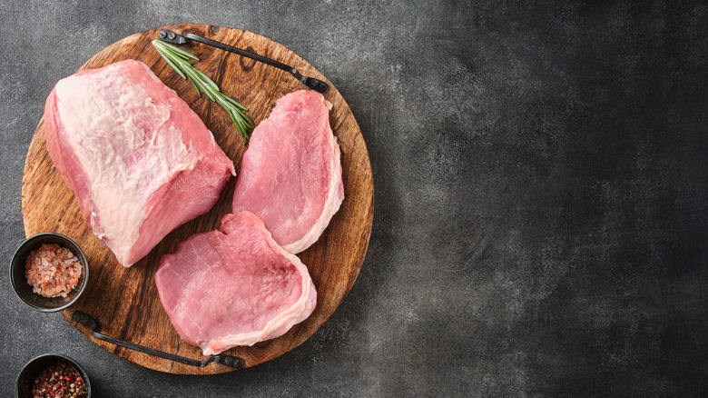 raw porks cut on wooden platter