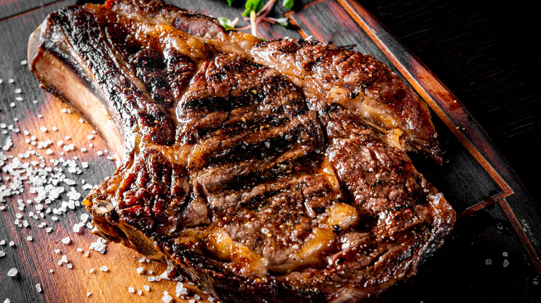 Close up of bone-in ribeye on wood