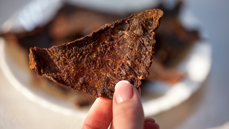 beef jerky being held in a person's hand