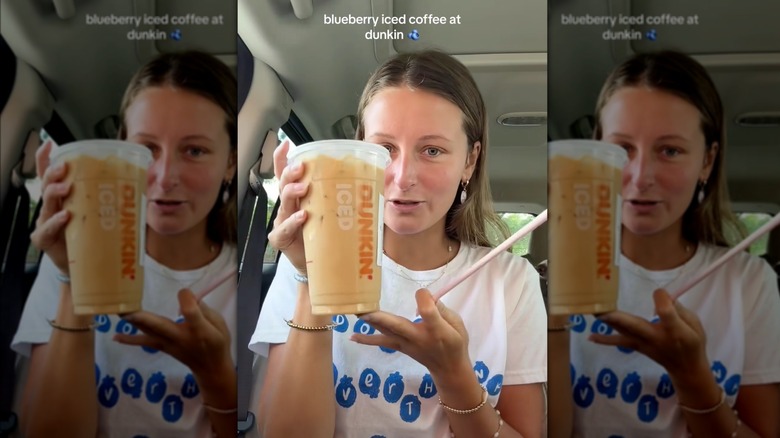 Person holding blueberry iced coffee