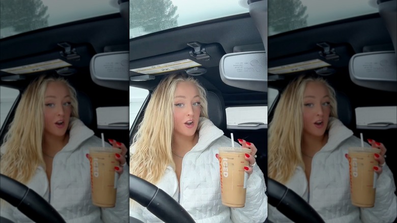Person holding mocha caramel iced coffee