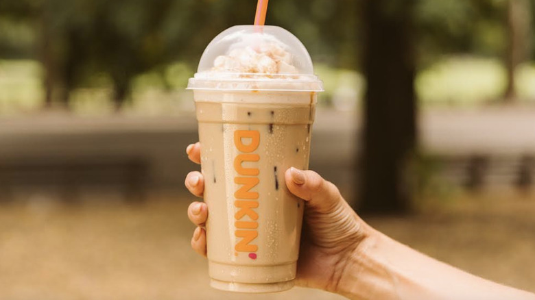 iced Dunkin' latte with orange straw