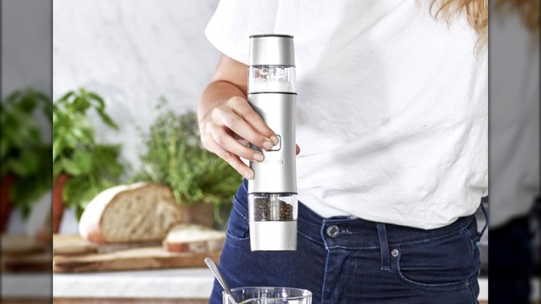 Woman holding Cuisnart salt grinder up