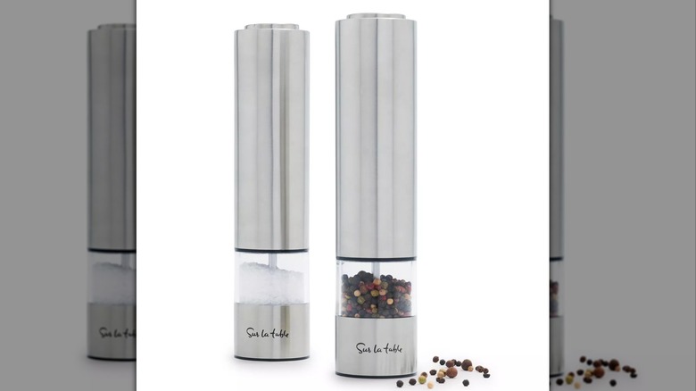 Stainless steel salt and pepper grinders filled with salt and pepper