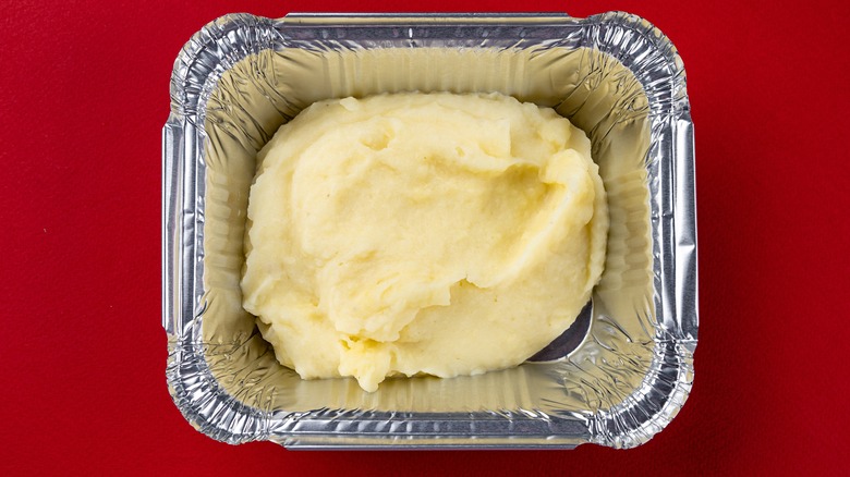 Take-out container of mashed potatoes