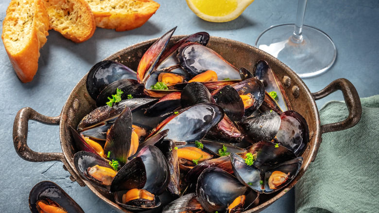 A pan of mussels with bread 