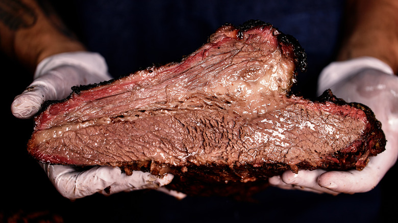 holding barbecued brisket