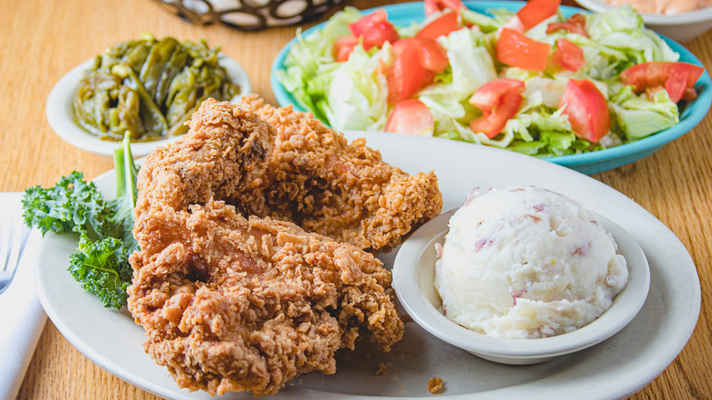 fried chicken with mashed potatoes and salad