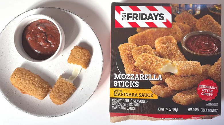 A box of TGI Fridays mozzarella sticks beside a plate with the sticks and marinara sauce