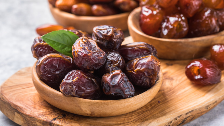 bowls of dates on wooden board