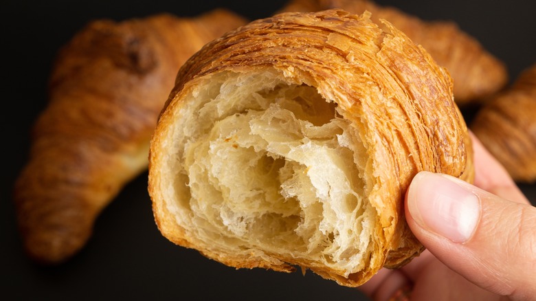 hand holding croissant interior