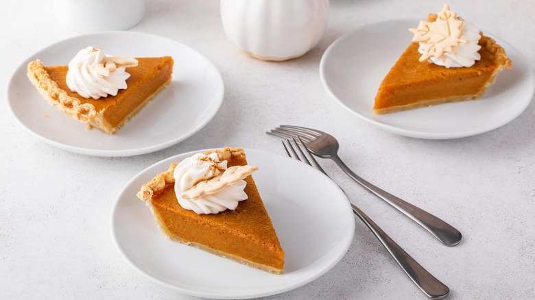 slices of pumpkin pie with whipped cream