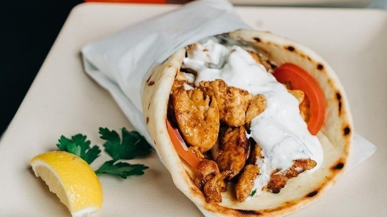 Tzatziki drizzled on gyro wrap