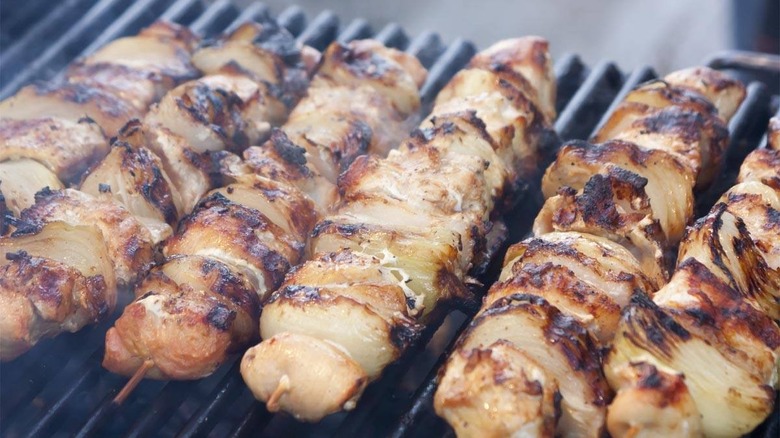 Chicken souvlaki roasting on the grill