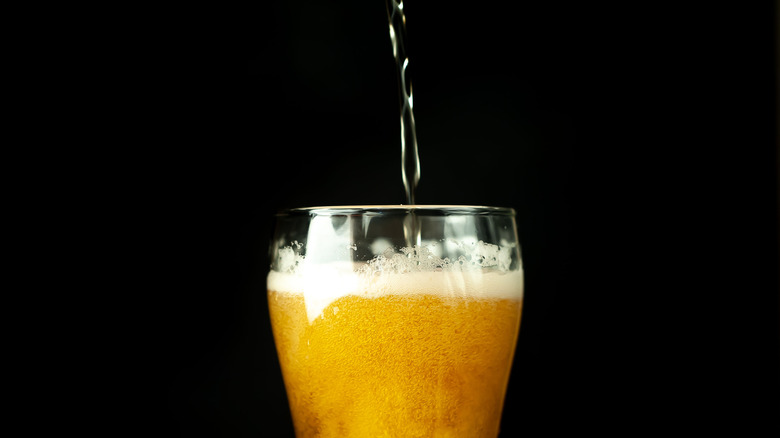 pouring light ale into glass