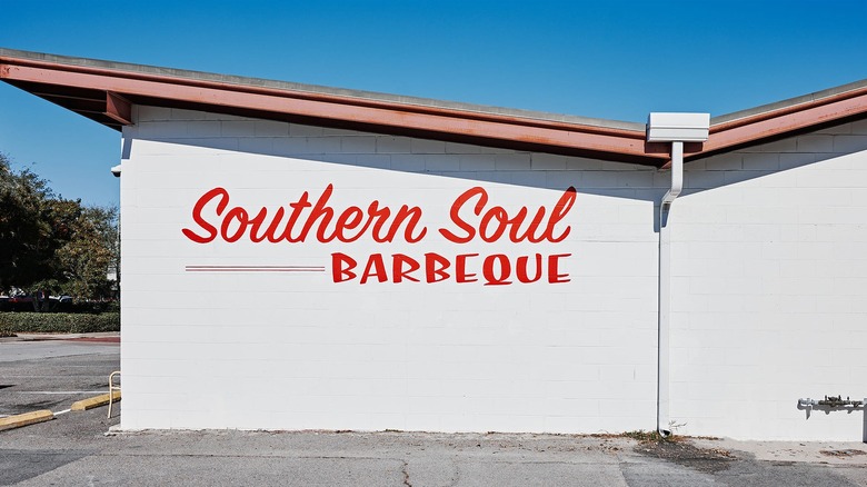 Outside of Southern Soul Barbeque building, red name on white wall in Georgia