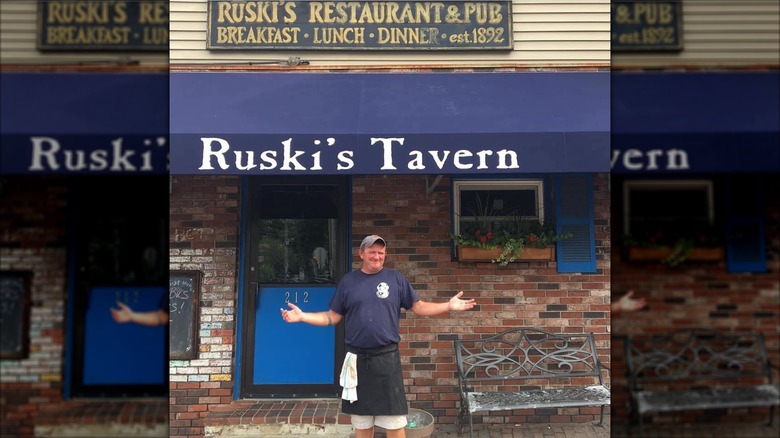 Man standing outside of Ruski's Tavern in Portland, Maine