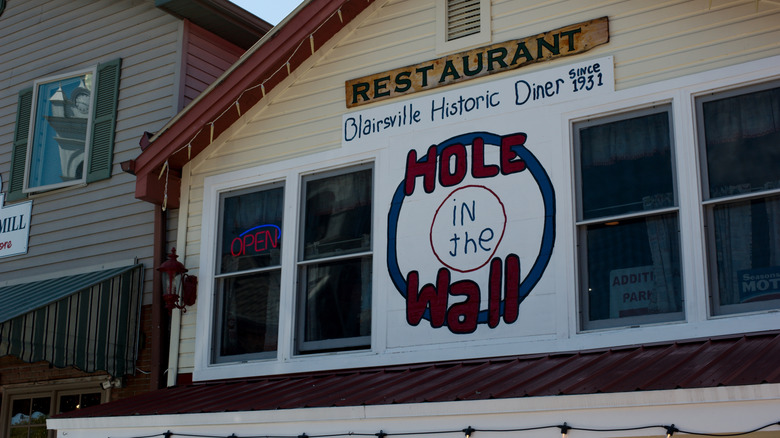 Restaurant exterior with Hole in the Wall sign