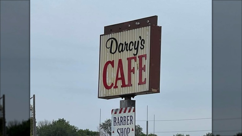 Darcy's Cafe sign against sky in North Dakota