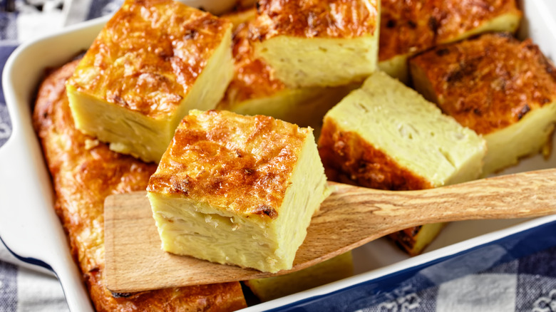 Kugel casserole and wooden spoon