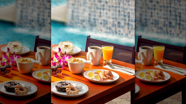 Orange table with white plates of breakfast items at Almond Tree Inn Key West