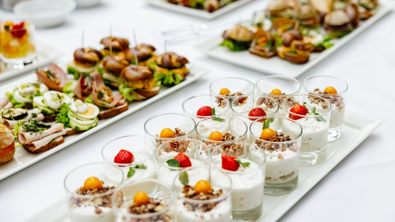 Assortment of food on platters on white tablecloth