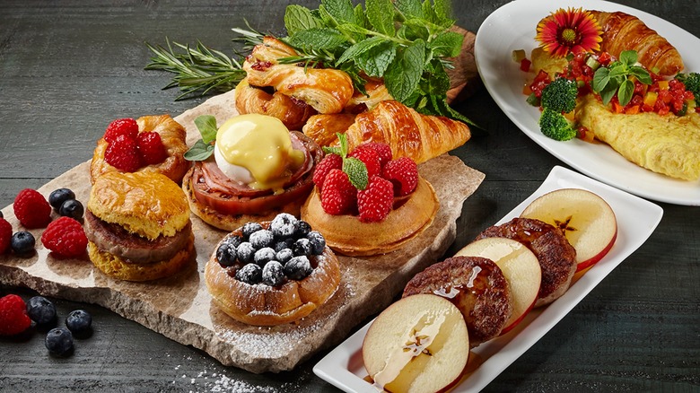 Array of breakfast pastries and fruit on black table at The Circle buffet at The Breakers