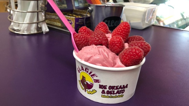 ice cream topped with raspberries