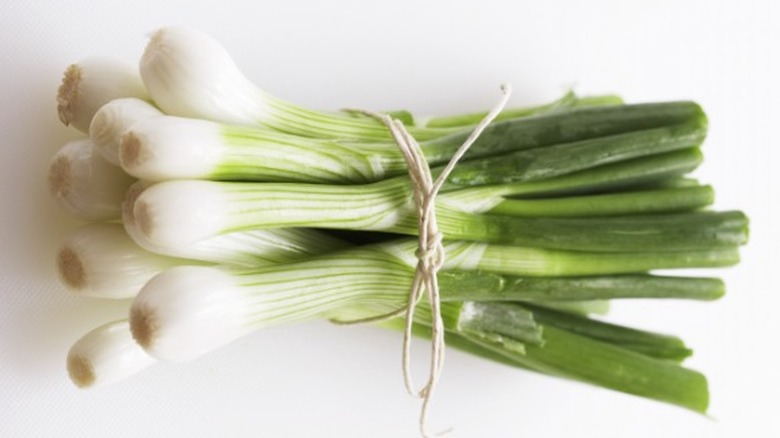 green onions on cutting board