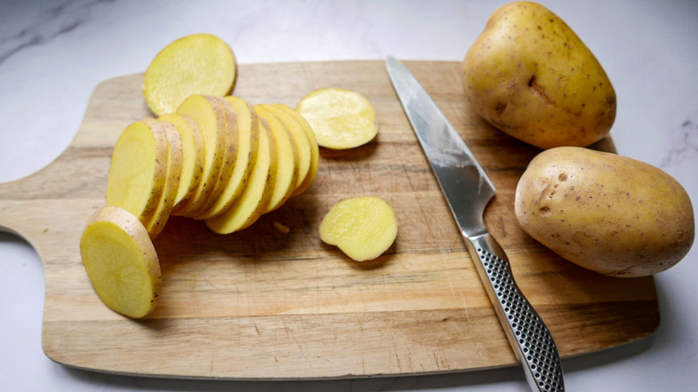 sliced potatoes on cutting board 