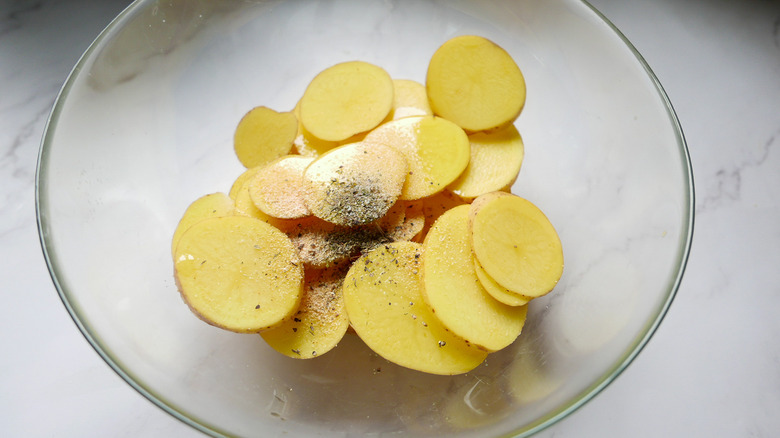 potatoes in bowl with seasonings