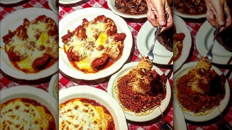 array of italian food on red and white table cloth