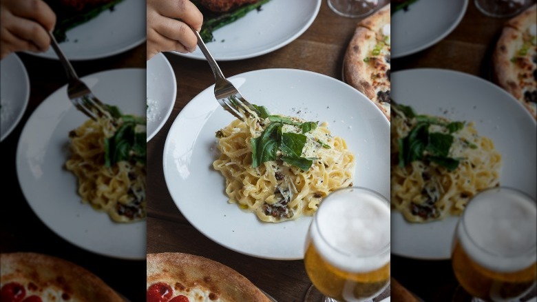 bowl of pasta, pizza, and beer