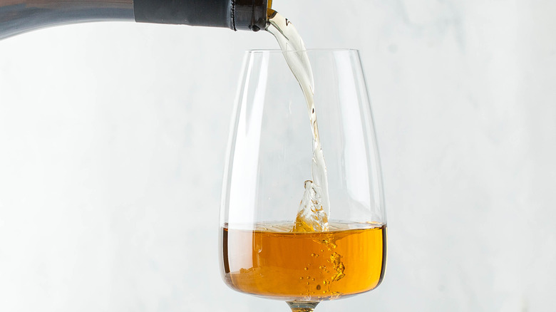 Pouring orange wine into glass