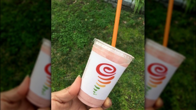 person holding jamba juice smoothie