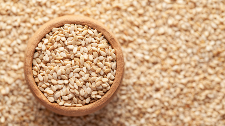 Sesame seeds background and bowl