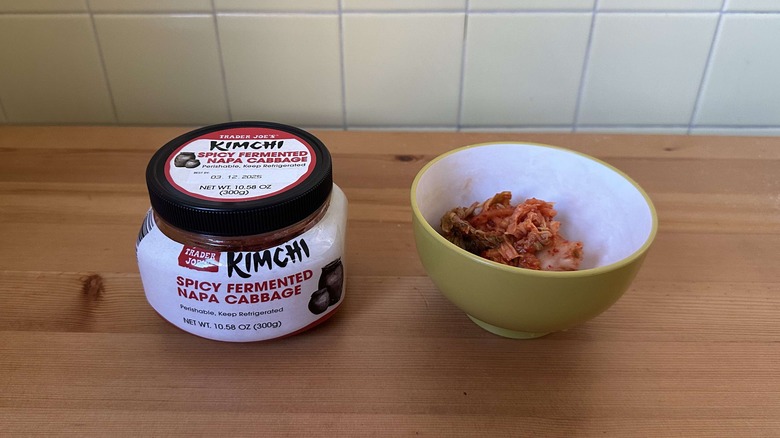 Jar of Trader Joe's kimchi on table next to bowl of kimchi