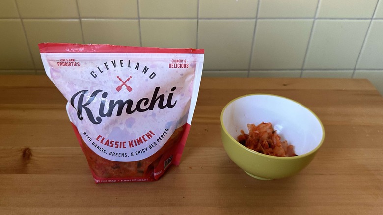 Bag of Cleveland Kitchen classic kimchi next to bowl of kimchi