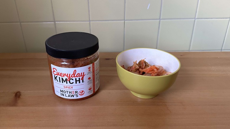 Mother in Law's kimchi in container on table next to bowl of kimchi