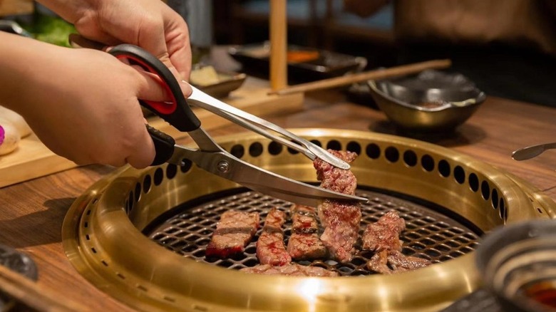 Grilled steak cut with scissors