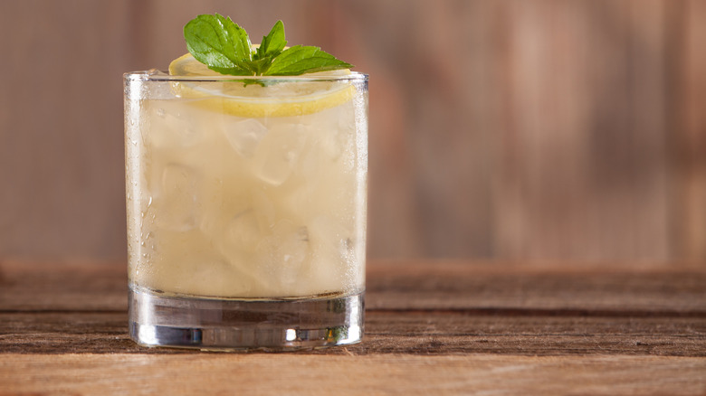 Vodka pineapple mixed drink in an ice-filled rocks glass