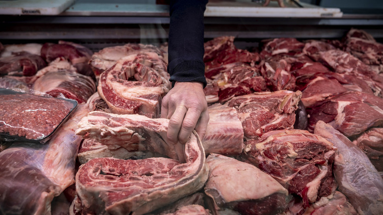 Butcher selecting meat