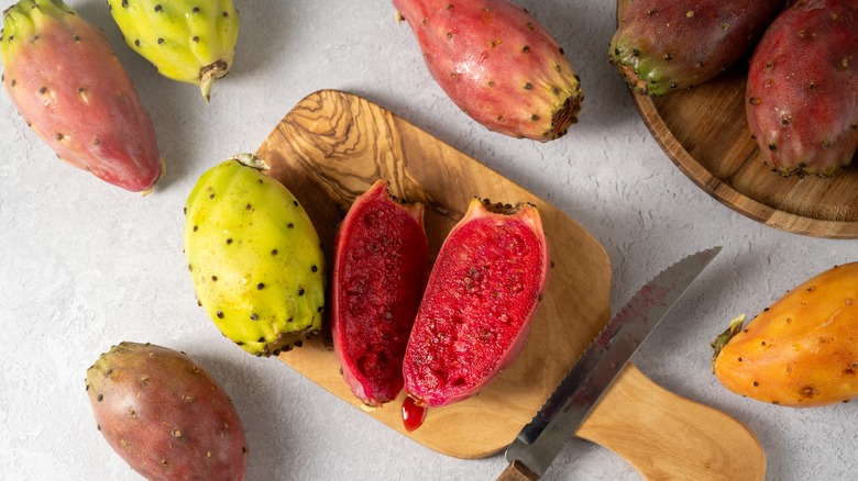 Halved prickly pears on cutting board