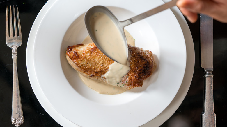 veloute poured over baked chicken