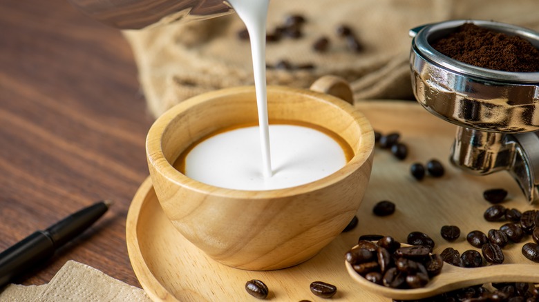 pouring milk in espresso drink