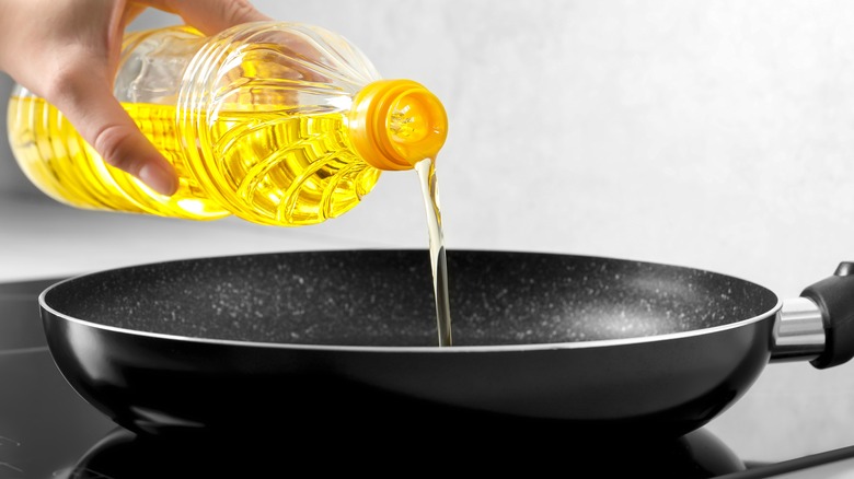 Oil pouring into frying pan