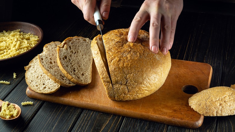 Hand slicing rye bread